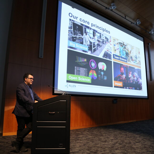 Rui Costa standing behind a podium during a presentation. -- biotech coverage from STAT