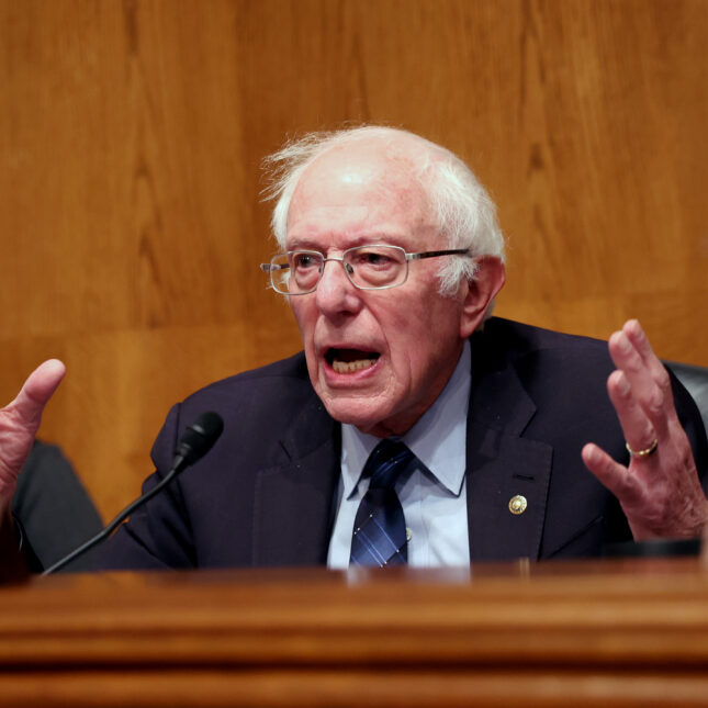 U.S. Sen. Bernie Sanders, wearing glasses and dark blue suit, gestures with both hands during the "Standing Up Against Corporate Greed: How Unions are Improving the Lives of Working Families" hearing — politics coverage from STAT