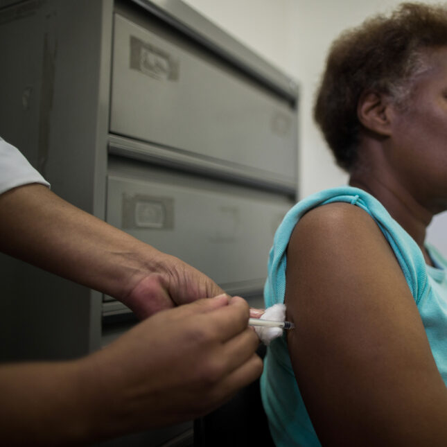 A person, sitting down, receives a Yellow Fever vaccine in Sao Paulo, Brazil — first opinion coverage from STAT