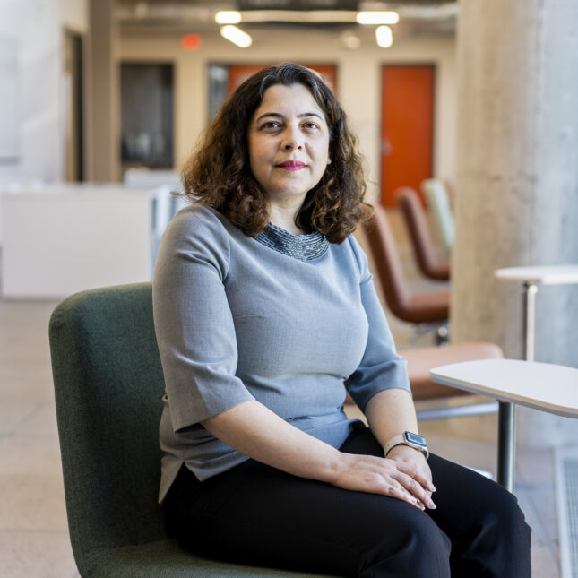 Dr. Nicole Hashemi poses for a portrait, sitting near a window with her hands crossed on her lap. -- health coverage from STAT